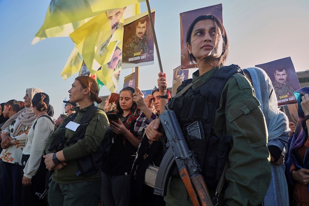 Female fighters from the Syrian Democratic Forces (SDF) attend a military parade before the funeral of senior Kurdistan Workers' Party (PKK) leader Nuredin Sofi, in Qamishli, northeastern Syria, Tuesday, Aug. 12, 2025 (AP)