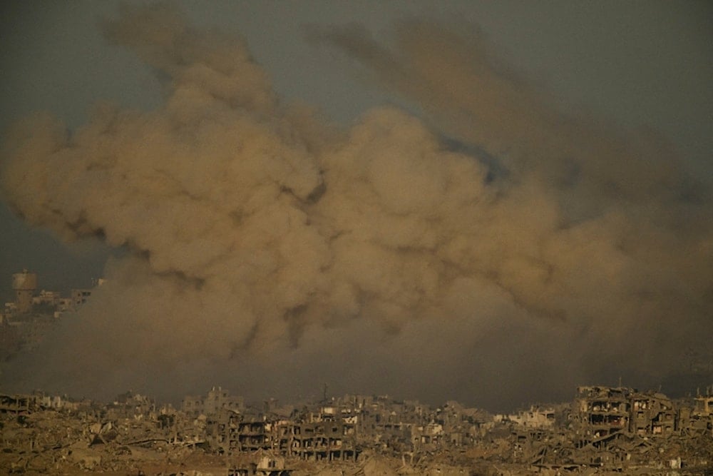 Buildings that were destroyed during the Israeli ground and air operations are engulfed by smoke following an Israeli military strike in the northern Gaza Strip, as seen from southern Israel, Saturday, September 20, 2025. (AP Photo/Leo Correa)