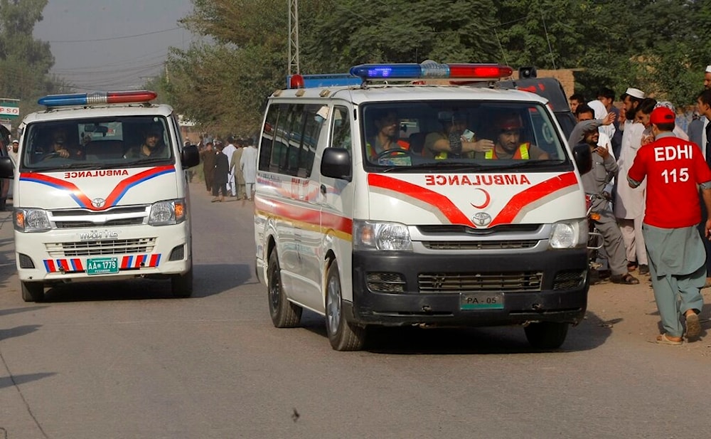 Ambulances carry injured to hospital outside an air force base in Peshawar, Pakistan, Friday, September 18, 2015. (AP Photo/Mohammad Sajjad)