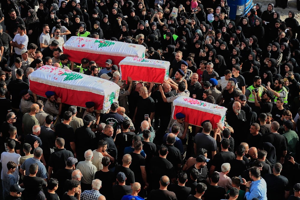 Mourners carry the coffins of four family members killed in an Israeli drone strike that hit their car, during a funeral procession in Bint Jbeil, southern Lebanon, Tuesday, Sept. 23, 2025 (AP)