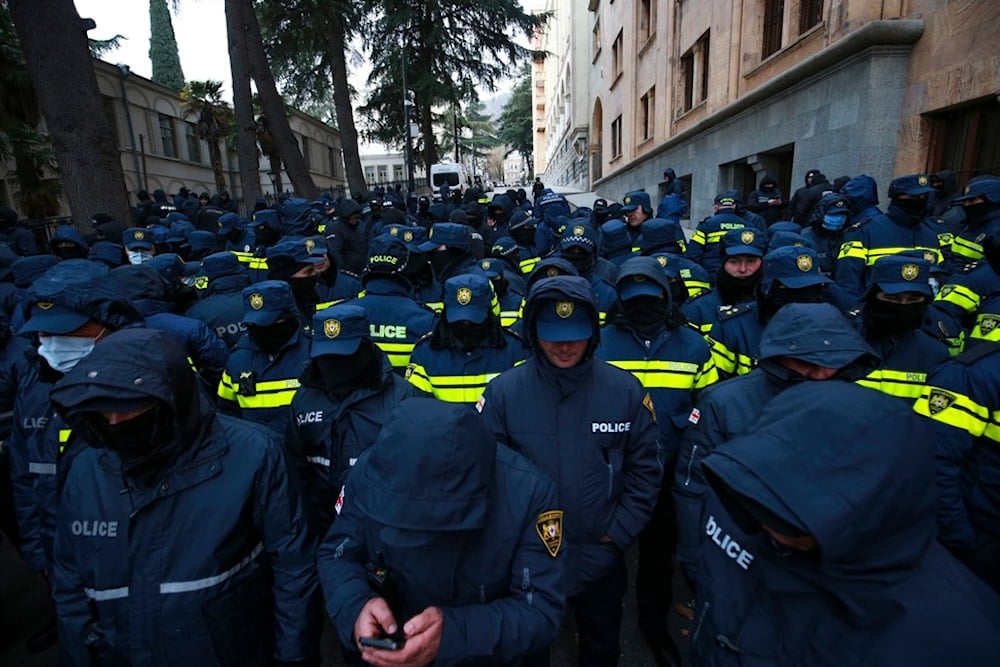 Police block a street to prevent demonstrators during a rally outside the parliament to protest against the government's decision to suspend negotiations on joining the European Union in Tbilisi, Georgia, Saturday, December 14, 2024 (AP)