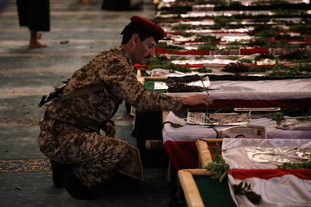 A Yemeni officer mourns over a coffin of one of 31 local journalists reportedly killed in Israeli airstrikes last week, during their funeral inside the Shaab Mosque in Sanaa, Yemen, Tuesday, September 16, 2025 (AP)