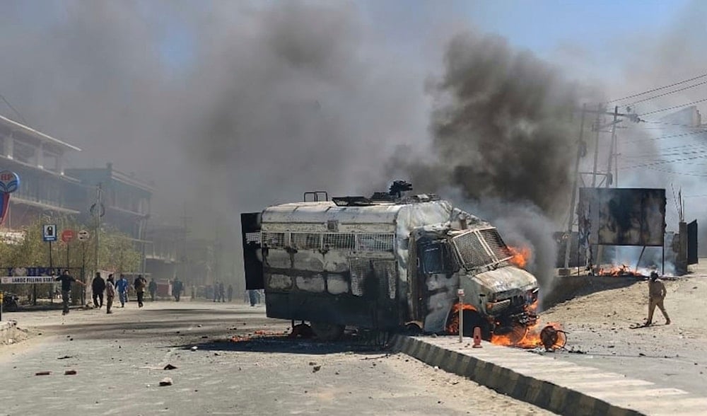 A police vehicle is set on fire during a protest by locals demanding federal statehood from the Indian government, in the high-altitude Leh town, in the region of Ladakh, India, Wednesday, Sept. 24, 2025. (AP)