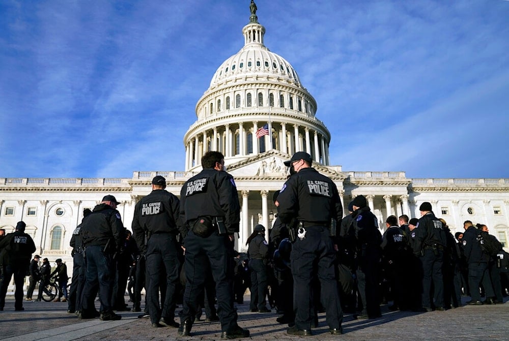 A large group of police arrive at the Capitol, Thursday, Jan. 6, 2022, in Washington (AP Photo/Evan Vucci)