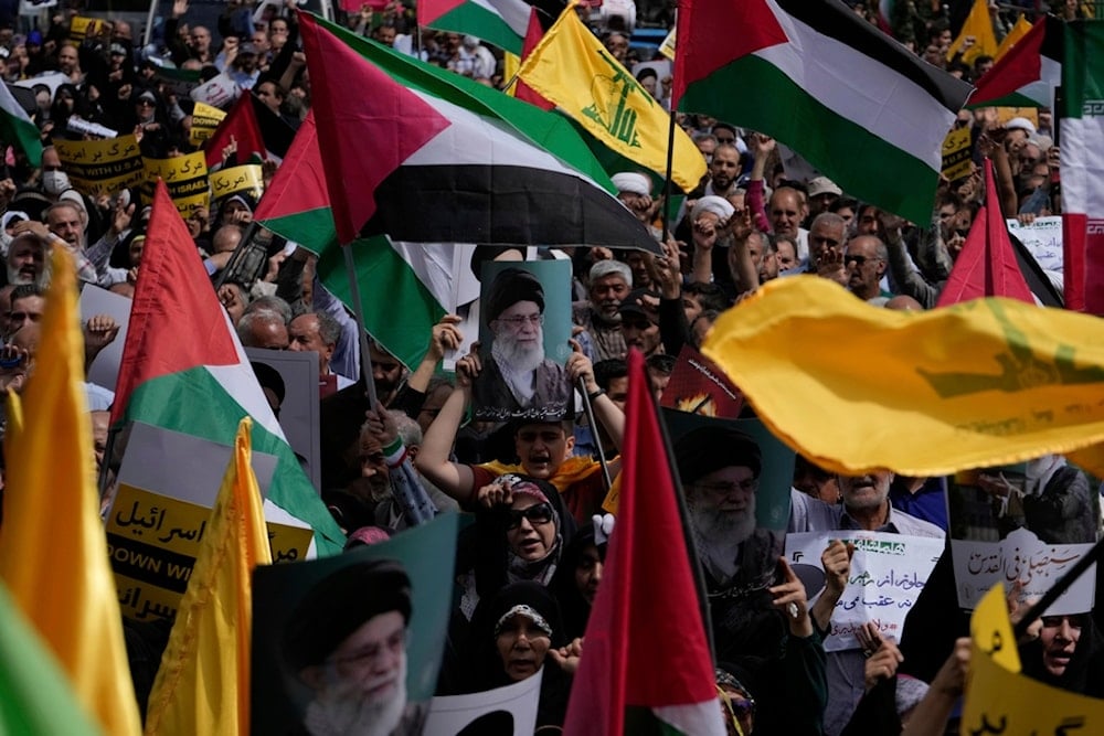 Iranian demonstrators hold posters of Leader Ayatollah Sayyed Ali Khamenei and Palestinian and Lebanon's Hezbollah flags in an anti-Israeli rally after their Friday prayer in Tehran, Iran, Friday, April 11, 2025 (AP)