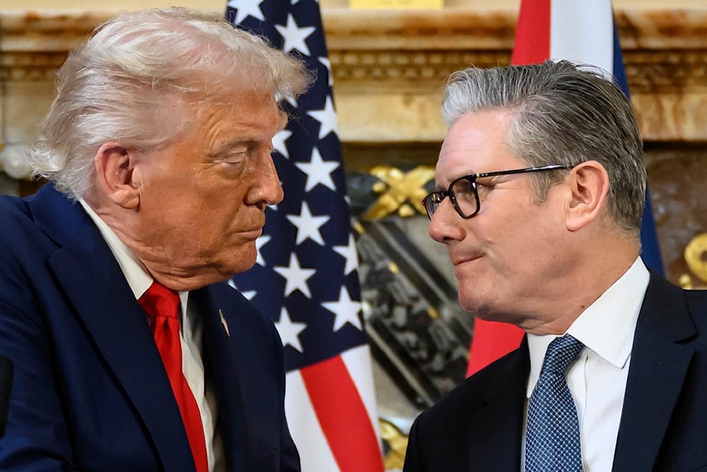 US President Donald Trump, left, and British Prime Minister Keir Starmer look at each other as they shake hands during a press conference at Chequers near Aylesbury, England, Thursday Sept. 18, 2025. (AP)