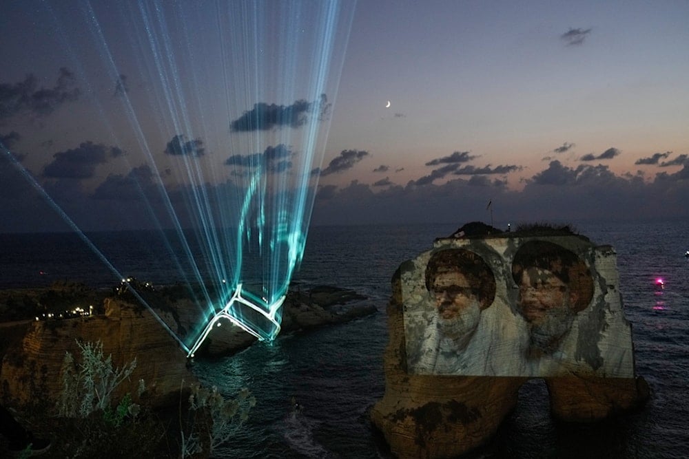 Portraits of the two former Hezbollah leaders, Sayyed Hassan Nasrallah and Sayyed Hashem Safeiddine, projected onto the Raouche rock during an event commemorating the leaders in Beirut, Lebanon, Thursday, September 25, 2025 (AP)