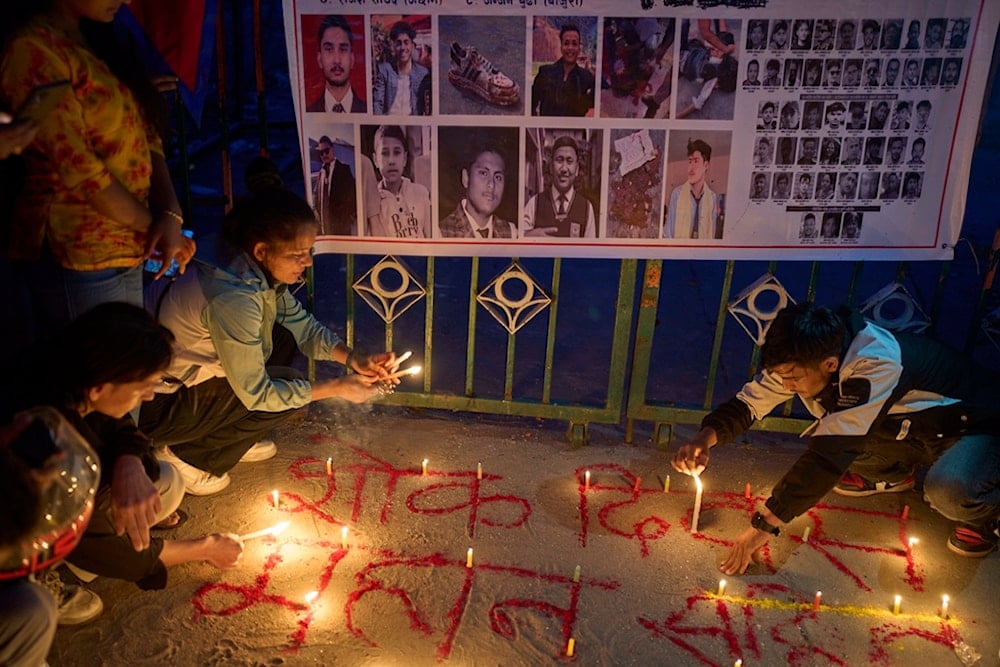 People light candles in memory of victims killed during the anti-corruption protest last week, in front of the parliament building in Kathmandu, Nepal, on Wednesday, September 17, 2025. (AP Photo/Niranjan Shrestha)