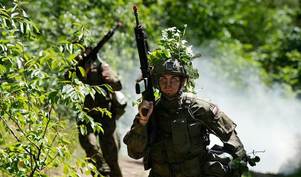 Volunteers in Poland's army practice tactics during basic training in Nowogrod, Poland, on Thursday, June 20, 2024. (AP)