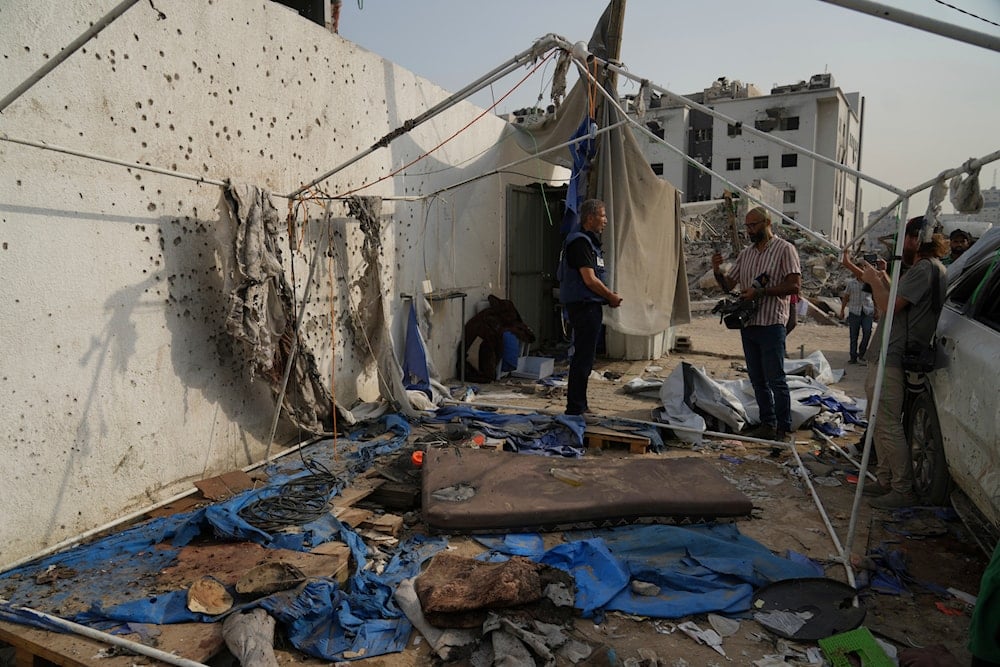 Palestinian inspect the destroyed tent where journalists, including Anas al-Sharif and Mohamed Qureiqa, were killed by an Israeli airstrike outside the Gaza City's Shifa hospital complex Monday, Aug. 11, 2025 (AP)