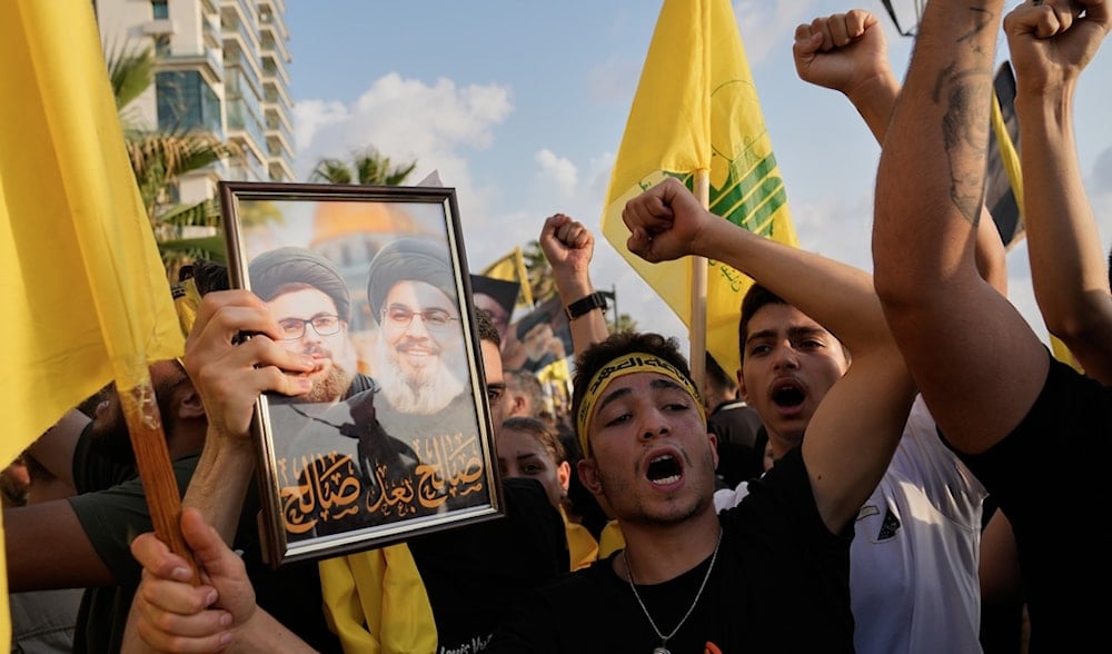Hezbollah supporters shout slogans during an event commemorating the anniversary of the martyrdom of Hezbollah leader Sayyed Hassan Nasrallah in Beirut, Lebanon, Thursday, Sept. 25, 2025. (AP)