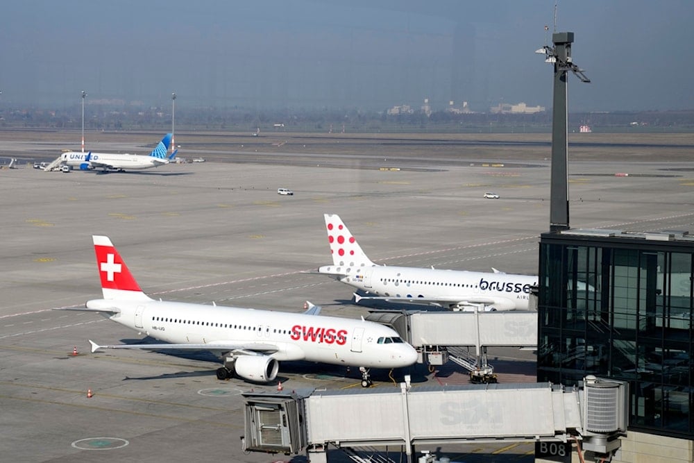 Airplanes park at the Berlin-Brandenburg airport while all major airports in Germany went on a warning strike, Germany, Monday, March 10, 2025. (AP Photo/Ebrahim Noroozi)