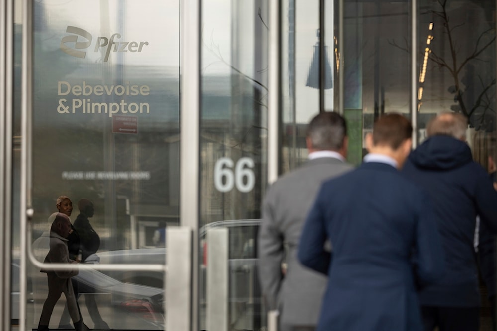 People enter the Pfizer NYC Headquarters, Thursday, April 10, 2025, in New York. (AP Photo/Yuki Iwamura)