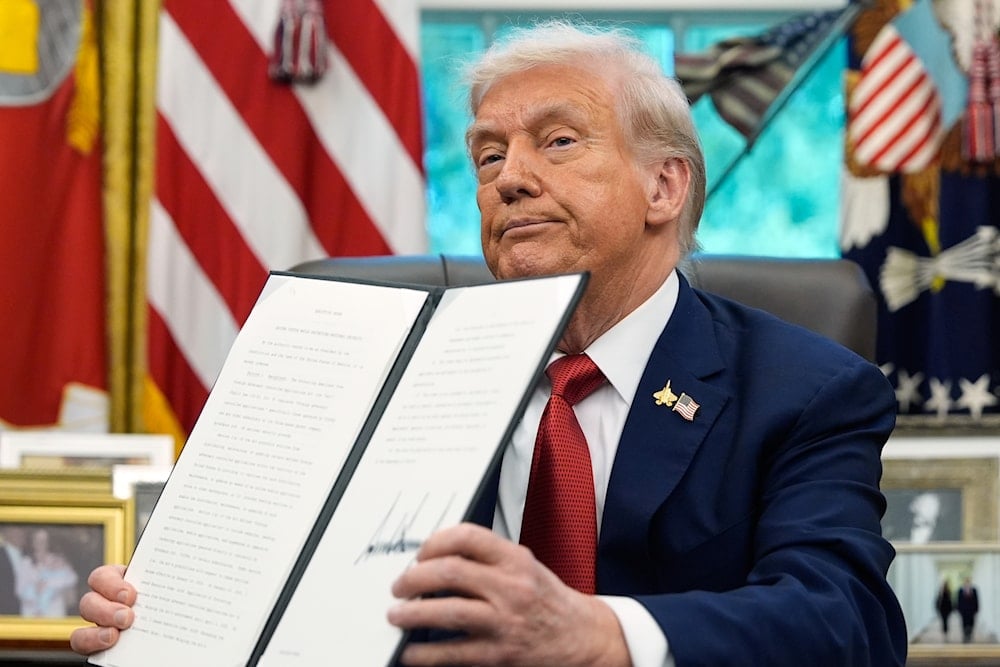 President Donald Trump holds a signed executive order regarding TikTok in the Oval Office at the White House, Thursday, Sept. 25, 2025, in Washington (AP)