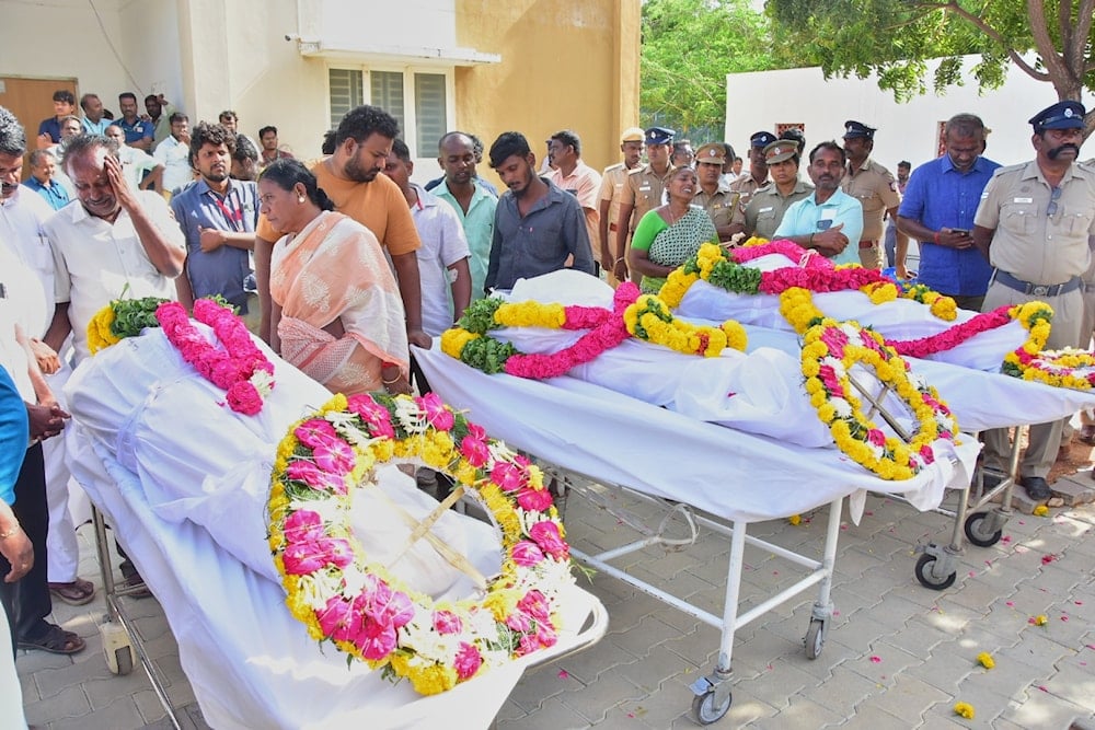 Relatives of people who were killed in a stampede during a rally for a popular Indian actor and politician, mourn as they take the bodies from a hospital, in Karur, in the southern state of Tamil Nadu, Sunday, Sept. 28, 2025 (AP)