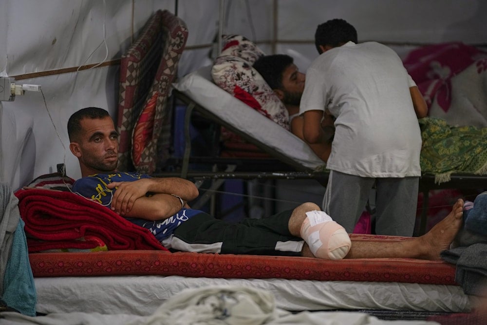 A patient lies in a bed at a field hospital operated by the British humanitarian medical NGO UK-Med in Muwasi, near Khan Younis in the southern Gaza Strip, Saturday, Sept. 27, 2025 (AP)