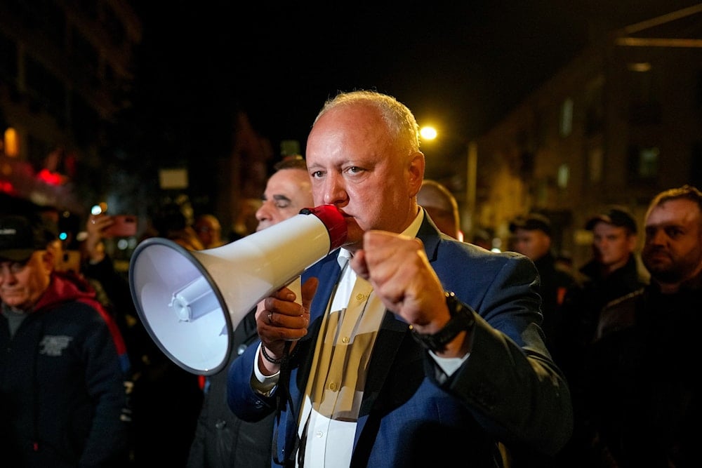 Former Moldovan President Igor Dodon, leader of the Patriotic Electoral Bloc, speaks to supporters gathered outside the Electoral Commission after the polls closed for the parliamentary election, in Chisinau, Moldova, Sunday, Sept. 28, 2025 (AP)