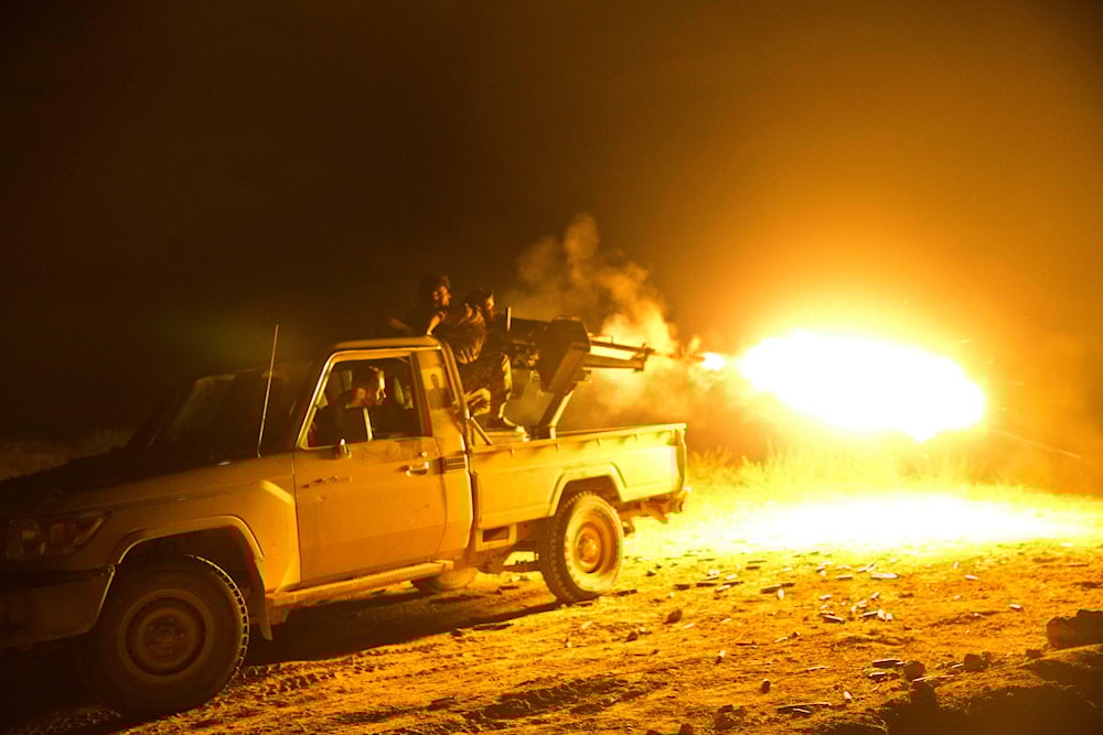 U.S.-backed Syrian Democratic Forces (SDF) fighter fire on Islamic State militant positions in Baghouz, Syria, March 18, 2019 (AP)