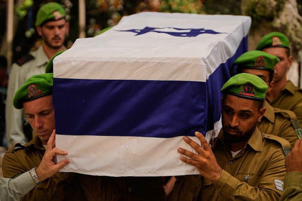 Israeli soldiers carry the flag-draped casket of Staff Sgt. Chalachew Shimon Demalash, who was killed in a battle in the Gaza Strip, during his funeral at the military cemetery in Beer al Sabe, Occupied Palestine, Thursday, Sept. 25, 2025 (AP)