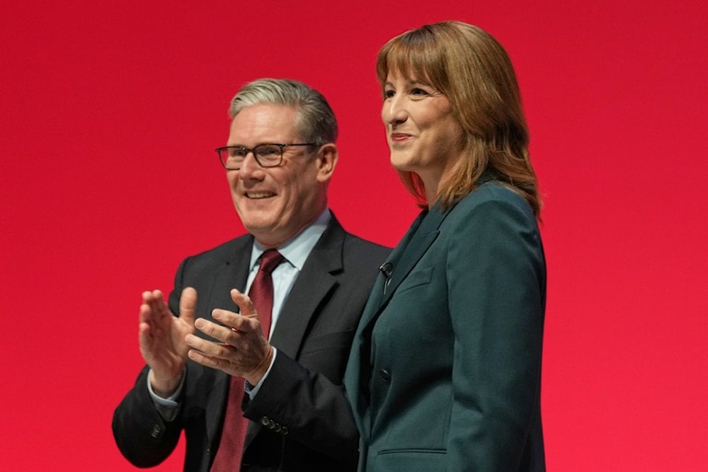 Britain's Chancellor of the Exchequer Rachel Reeves, left, stands next to the Prime Minister Keir Starmer during the annual Labour Party conference in Liverpool, England, Monday, Sept. 29, 2025. (AP Photo/Jon Super)