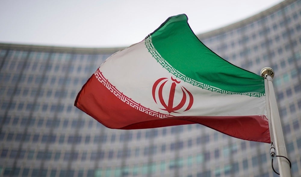A national flag of Iran waves in front of the building of the International Atomic Energy Agency, IAEA, in Vienna, Austria, Friday, Dec. 17, 2021. (AP)