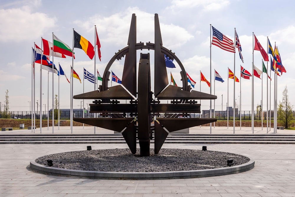 Flags of the Alliance members flap in the wind prior to a coalition of the willing defence ministers meeting at NATO headquarters in Brussels, Belgium, Thursday, April 10, 2025 (AP)