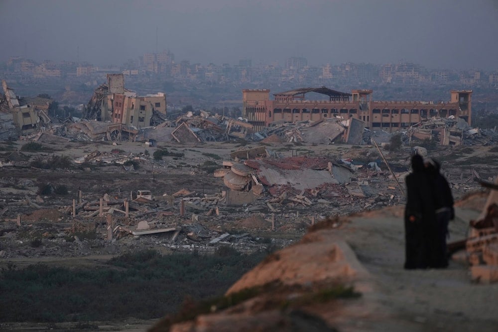 Palestinians look at the destruction caused by the Israeli war on Gaza, in the central Gaza Strip, Thursday, Sept. 4, 2025 (AP)