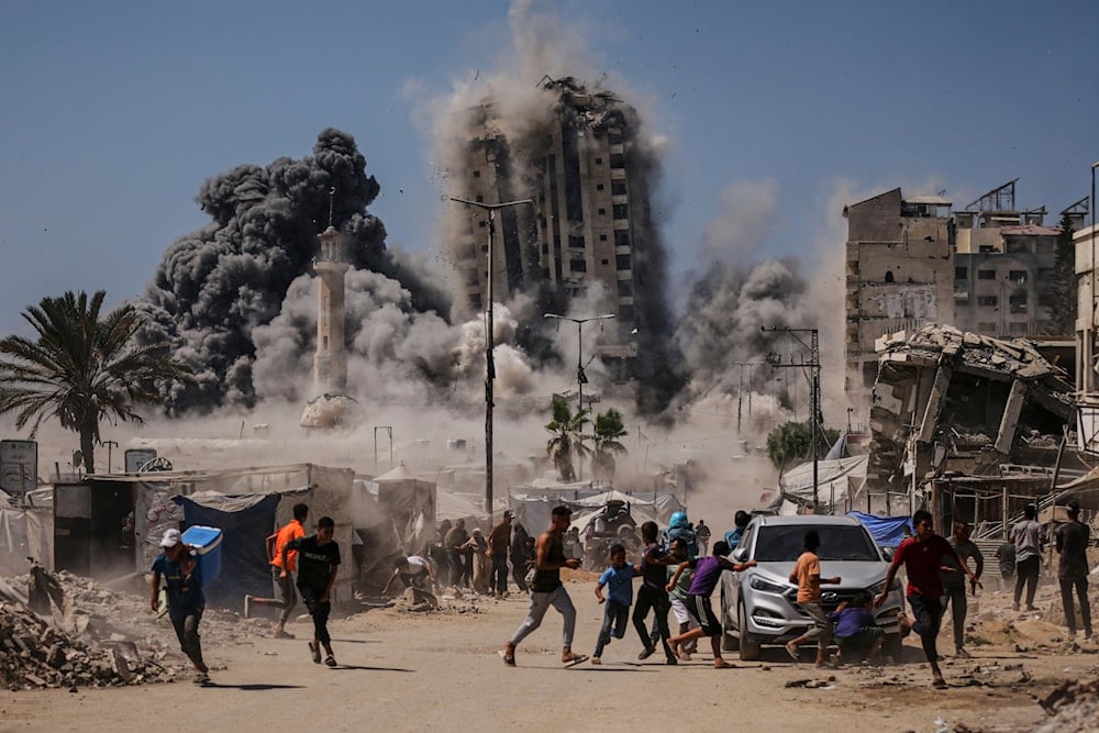 Palestinians run for cover during an Israeli airstrike on a high-rise building in Gaza City, Friday, Sept. 5, 2025 (AP)