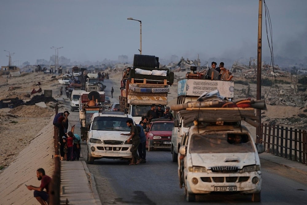 Displaced Palestinians fleeing northern Gaza carry their belongings along the coastal road toward southern Gaza, Saturday, September 6, 2025 (AP)
