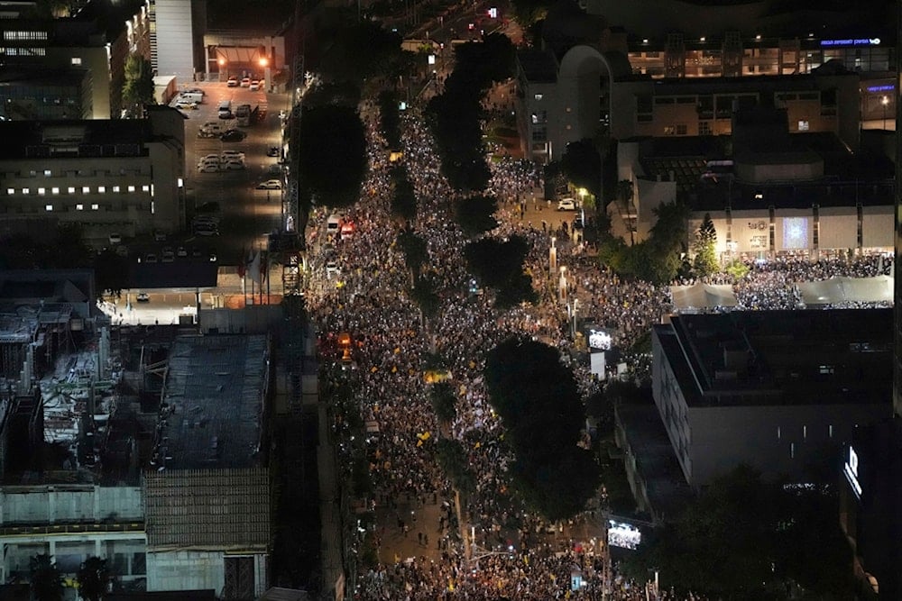People take part in a protest demanding the immediate release of all captives held by the Palestinian Resistance and calling for the end of the war in the Gaza Strip, in Tel Aviv, Israel, Tuesday, Aug. 26, 2025. (AP Photo/Ohad Zwigenberg)