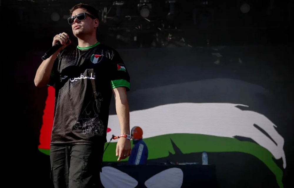 One of the members of the band Kneecap, during their concert at Rock en Seine, on August 24, 2025. (AFP)