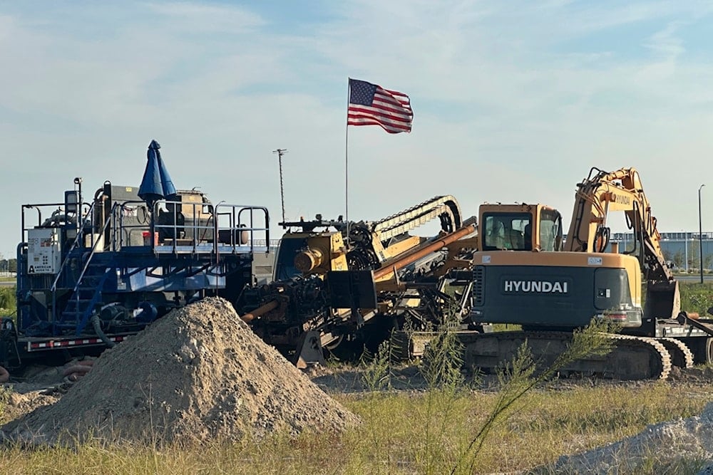An American flag flies above a piece of heavy machinery at the site of Hyundai Motor Group's electric vehicle plant in Ellabell, Georgia, Friday, Sept. 5, 2025. (AP Photo/Russ Bynum)