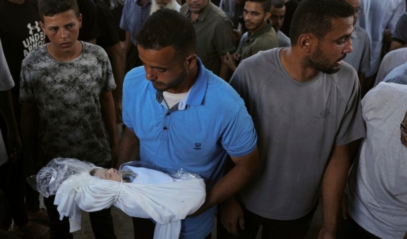 A relative carries the body of Palestinian infant Jabr Al-Ashhab, who was killed in an Israeli military strike, during his funeral outside Shifa Hospital in Gaza City, Thursday, Sept. 4, 2025. (AP)