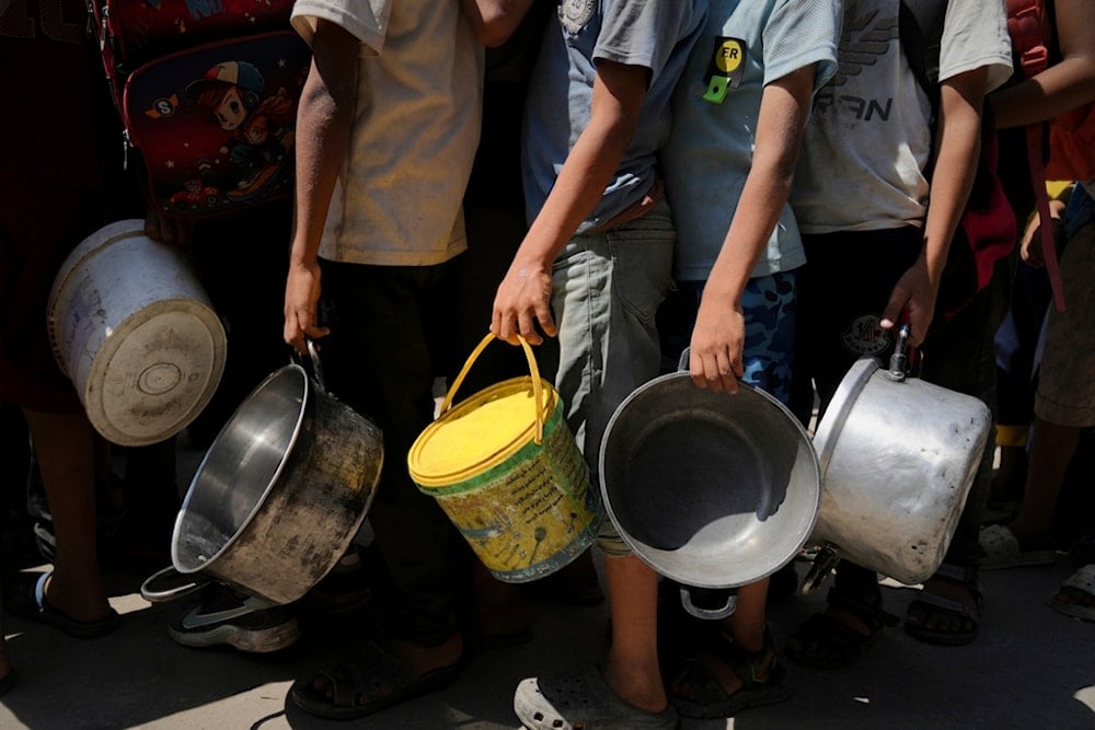 Palestinians line up to receive donated food at a community kitchen in Deir al-Balah, southern Gaza Strip, Saturday, September 6, 2025 (AP)