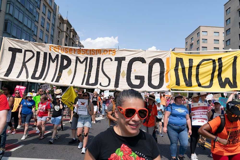 Demonstrators protest against US President Donald Trump's deployment of federal law enforcement and National Guard troops in Washington during a march on Saturday, Sept. 6, 2025. (AP Photo/Jose Luis Magana)
