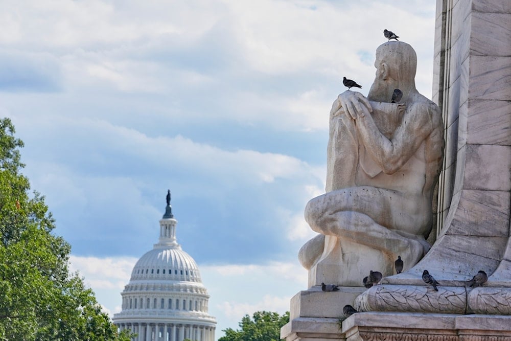 Pigeons sit on Columbus Fountain at Union Station, as the U.S. Capitol building is seen in the background, Tuesday, Aug. 26, 2025, in Washington. (AP Photo/Mariam Zuhaib)