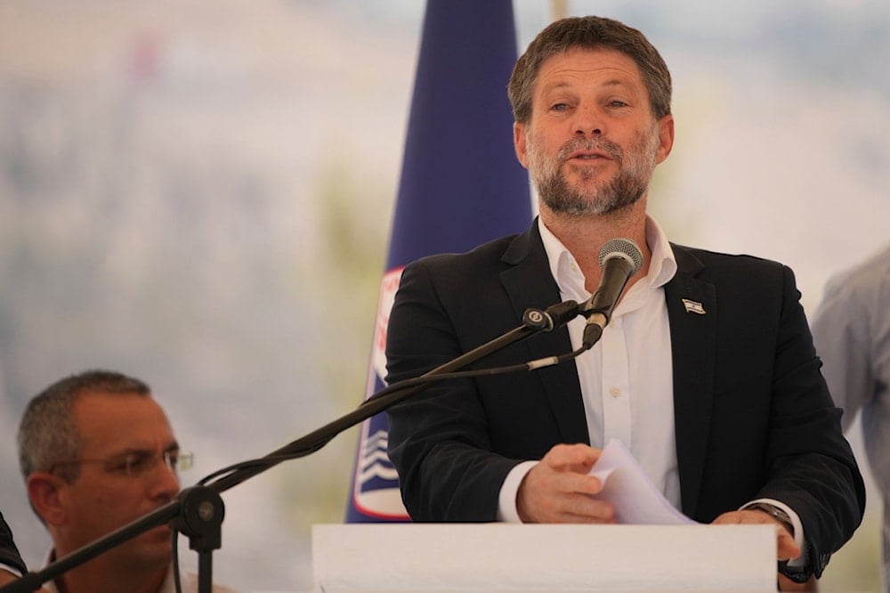 Israeli Finance Minister Bezalel Smotrich speaks to journalists during a press conference about new settlement construction in the Israel-occupied West Bank near Maale Adumim, Thursday, August 14, 2025 (AP)